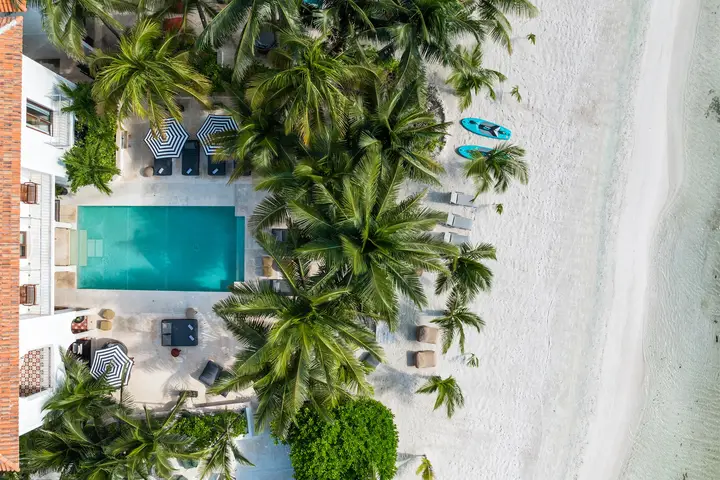 Hacienda Mágica from above: the house, its pool and palms, and the white-sand beach on the Caribbean
