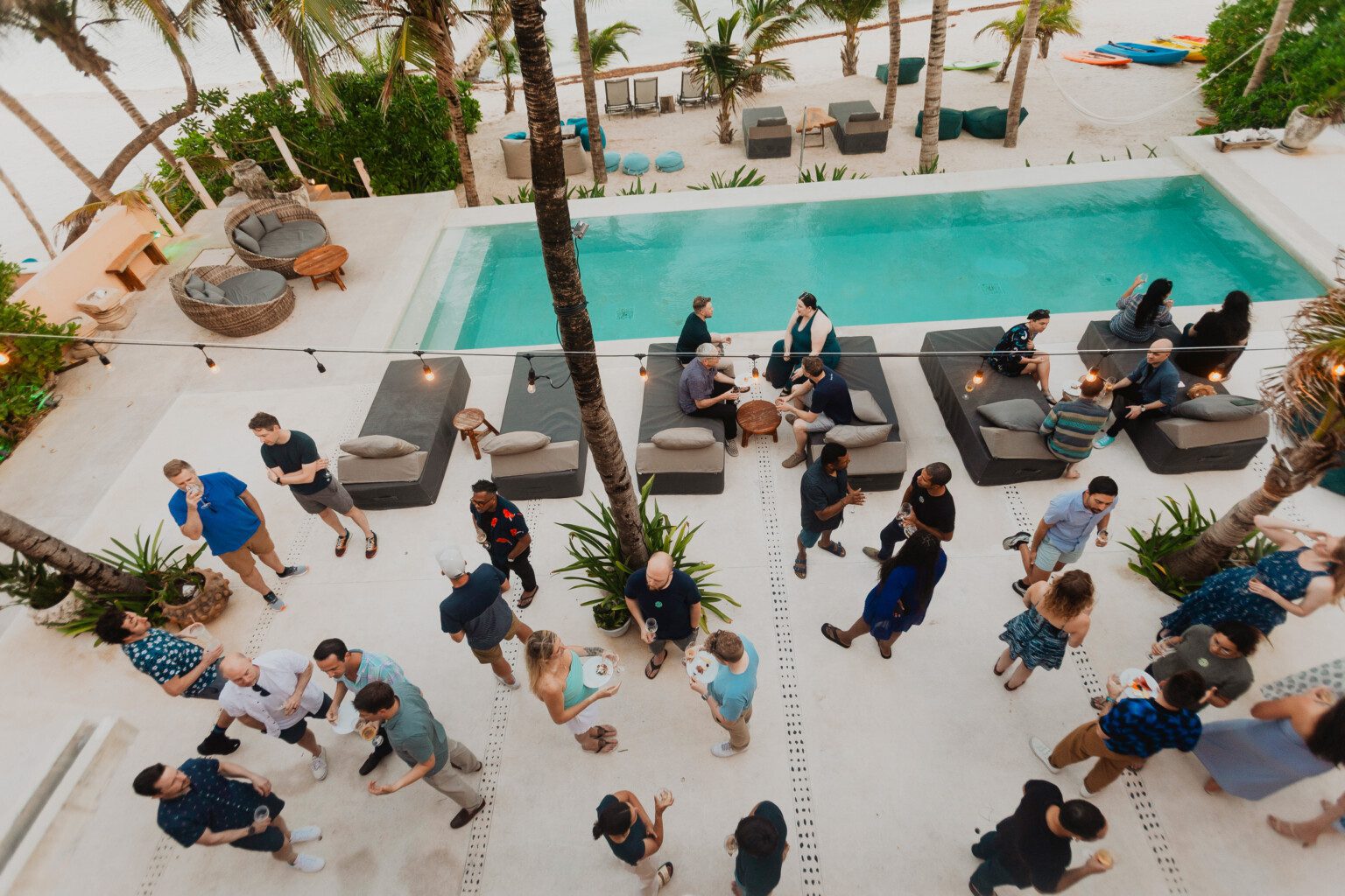 A family gathering around a hacienda pool, seen from above