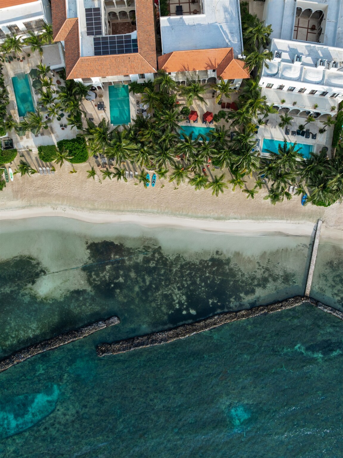 The haciendas and their pools from the air, above the beach