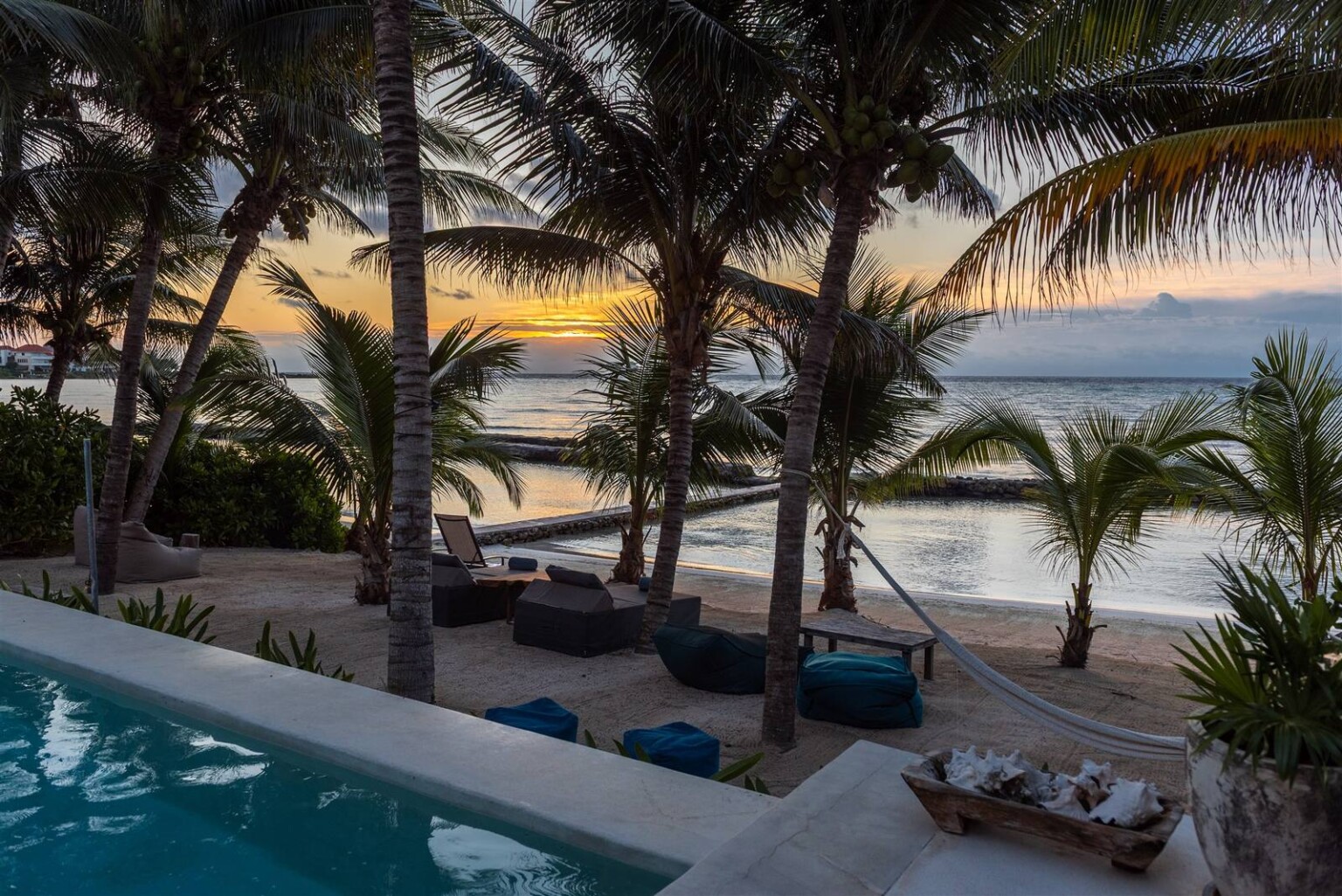 The pool at Hacienda Del Mar at sunset, palms against the sky