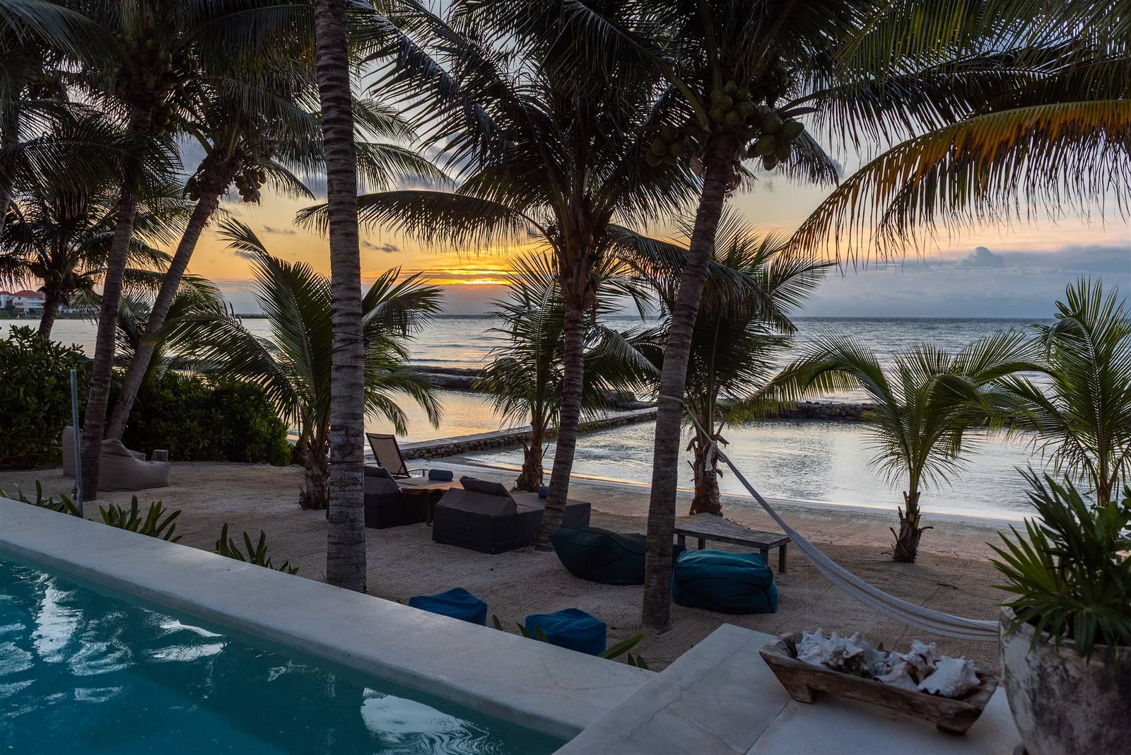 The pool at Hacienda Del Mar at sunset, palms against the sky