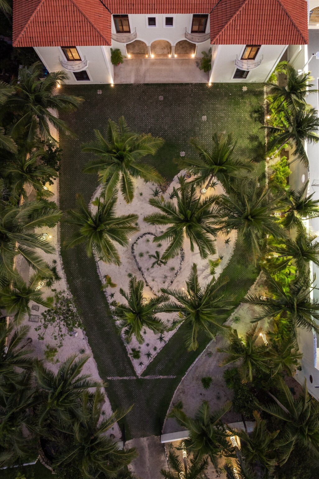 The heart-shaped garden of Hacienda Corazón from above, lit at dusk