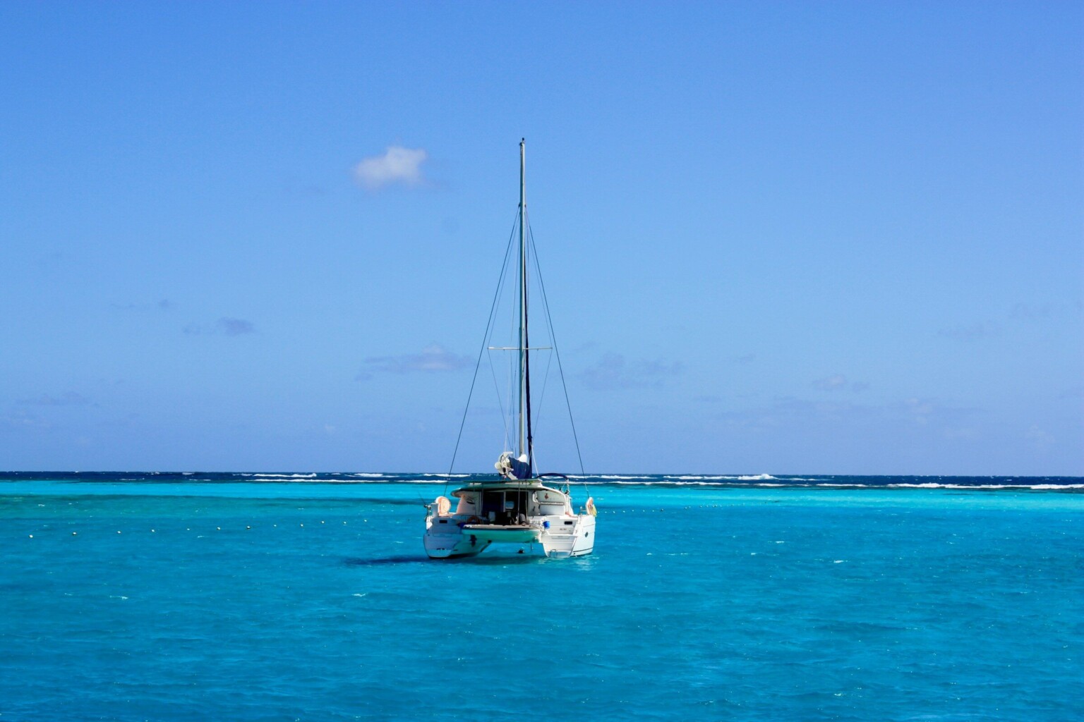 A white catamaran on turquoise water