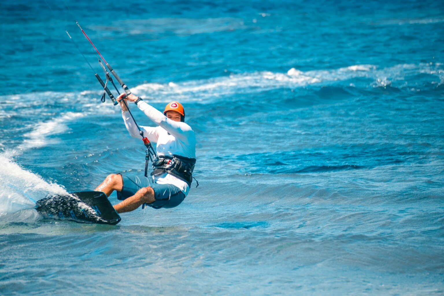 A kitesurfer on turquoise water
