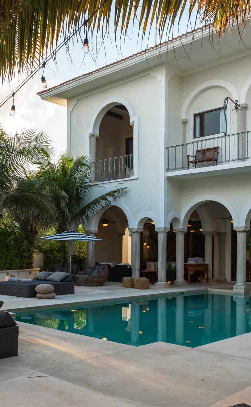 Hacienda Mágica rising behind its pool and palms