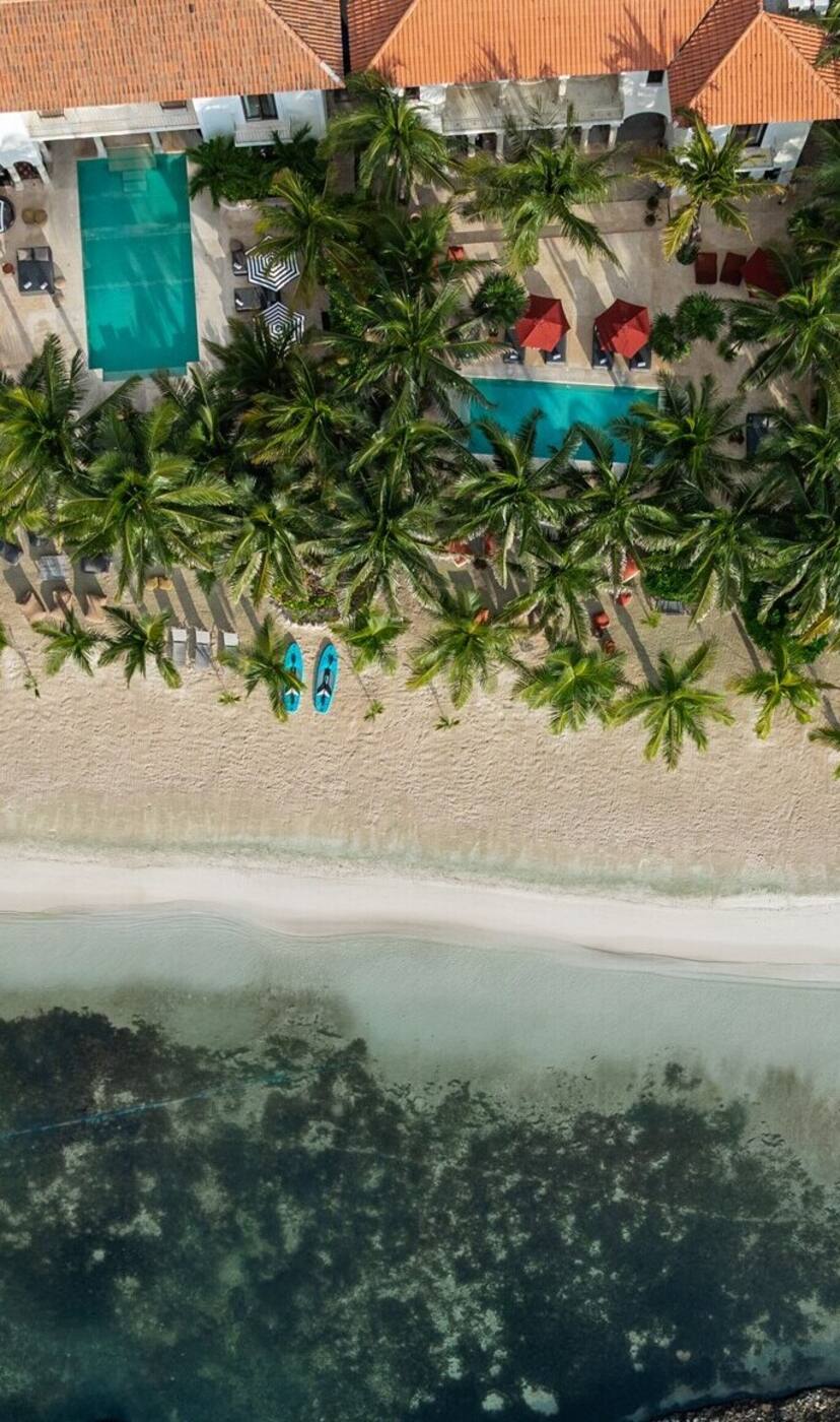 The haciendas and their pools from the air, above the beach in Puerto Aventuras