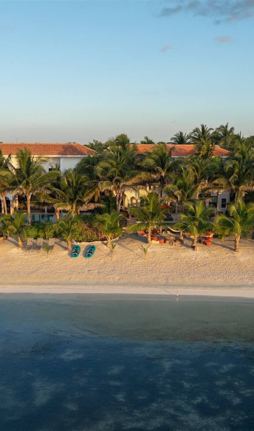 The four haciendas side by side on the beach in Puerto Aventuras, seen from the sea at golden hour