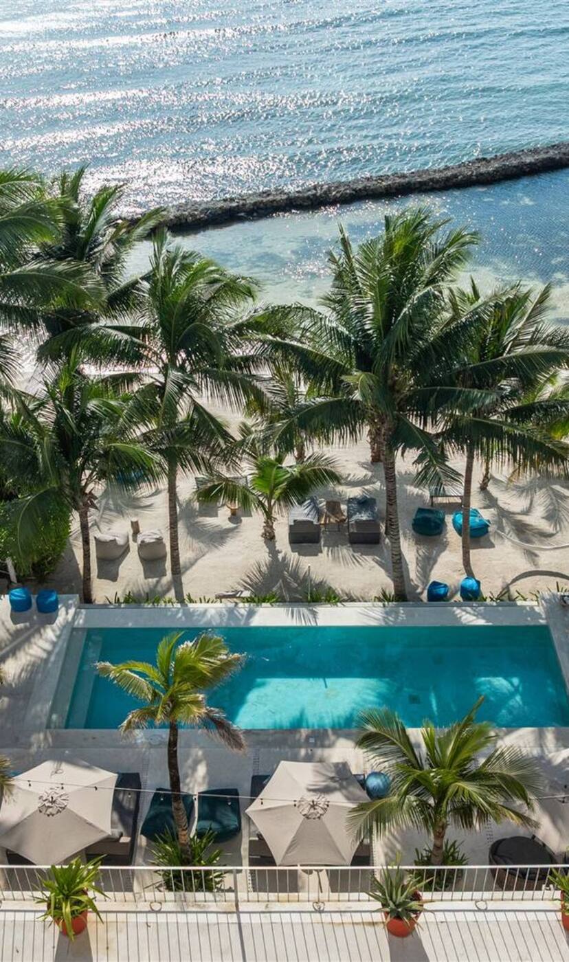 A hacienda pool and terrace above the beach, seen from the air