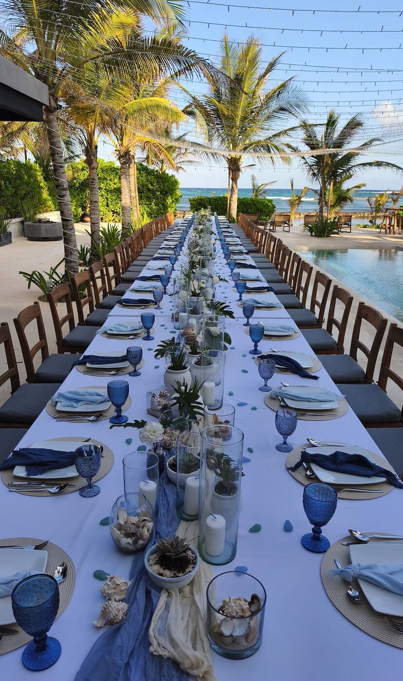 A long table set beside a pool that runs to the sea at Hacienda Jaguar